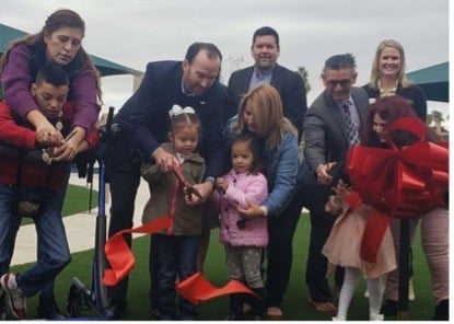 children cut ribbon at all access playground